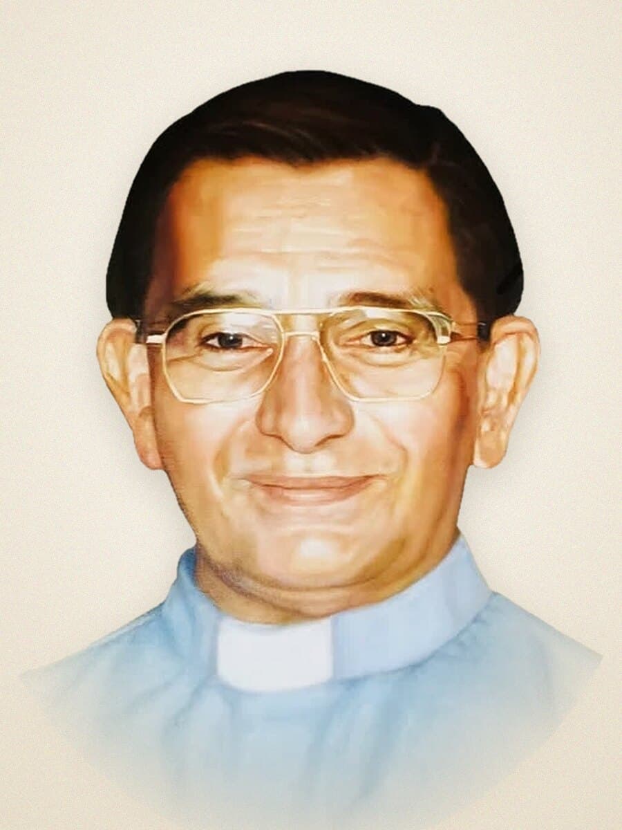 Msgr. Frederick “Fred” Kriekenbeek, smiling, in glasses and a light blue clerical shirt