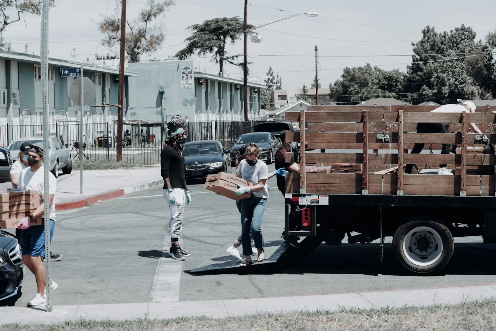 A man beside a trailer loaded with boxes.