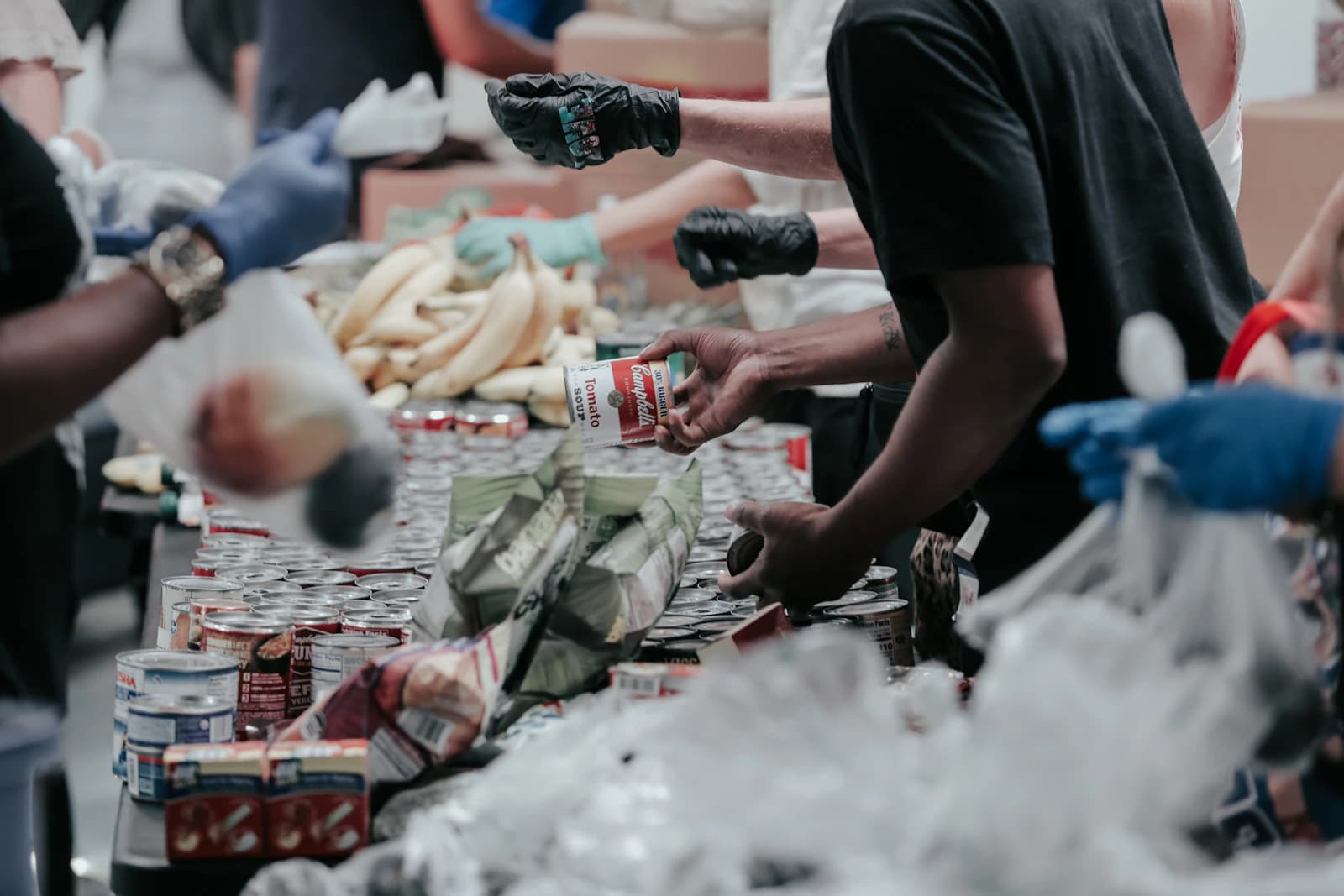 Volunteers sorting canned food donations.